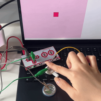 Alligator clips are hooked onto different pins and arrow keys to act as buttons