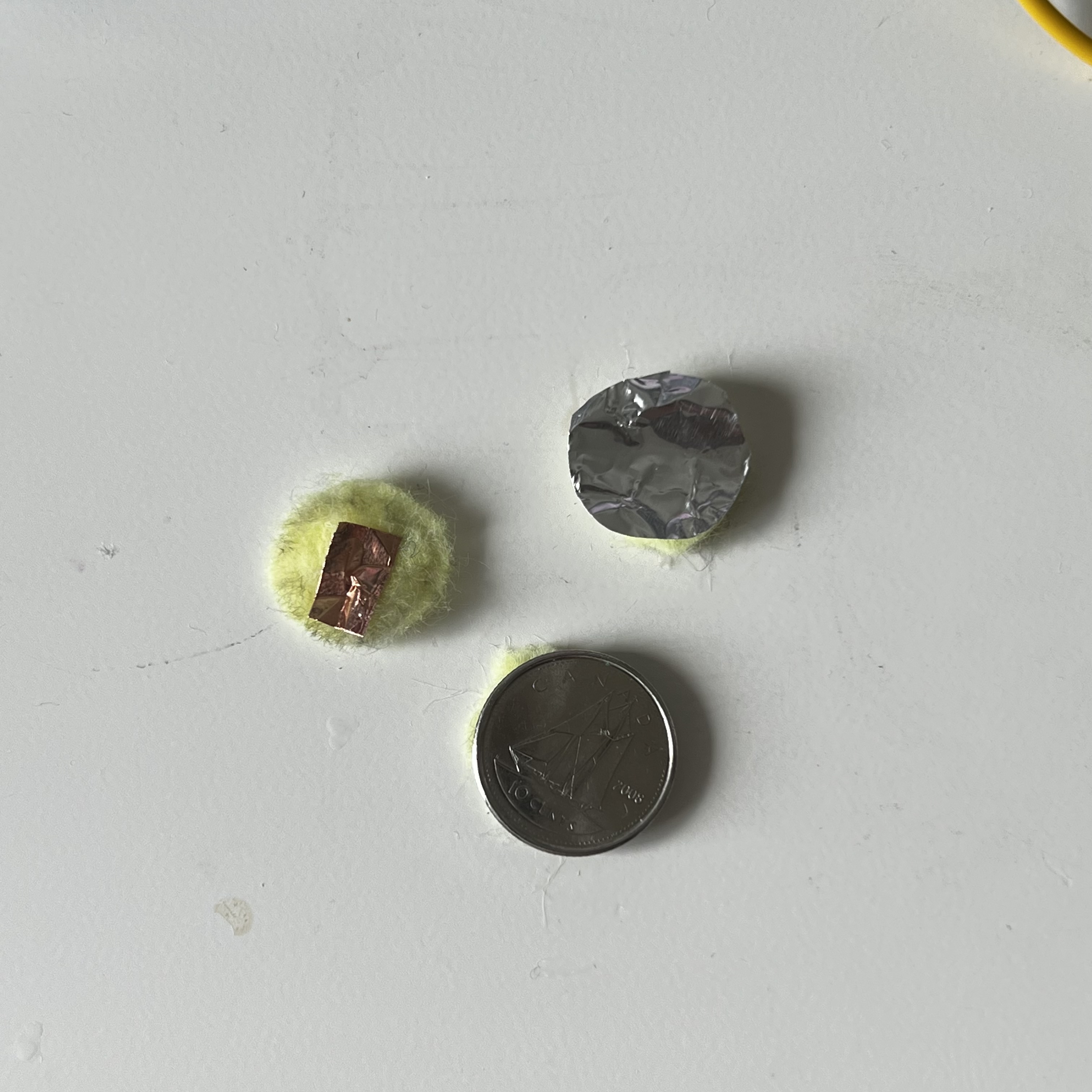 Making felt buttons conductive with different materials